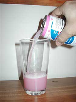 Pouring the fermented milk soft drink into the glass